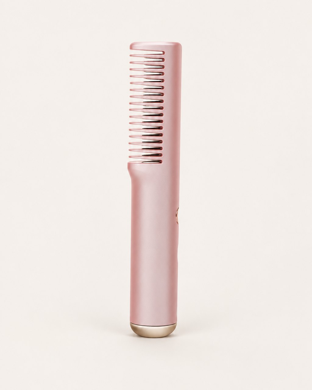 Pink cordless straightening comb with its single row of heated teeth, on a light background
