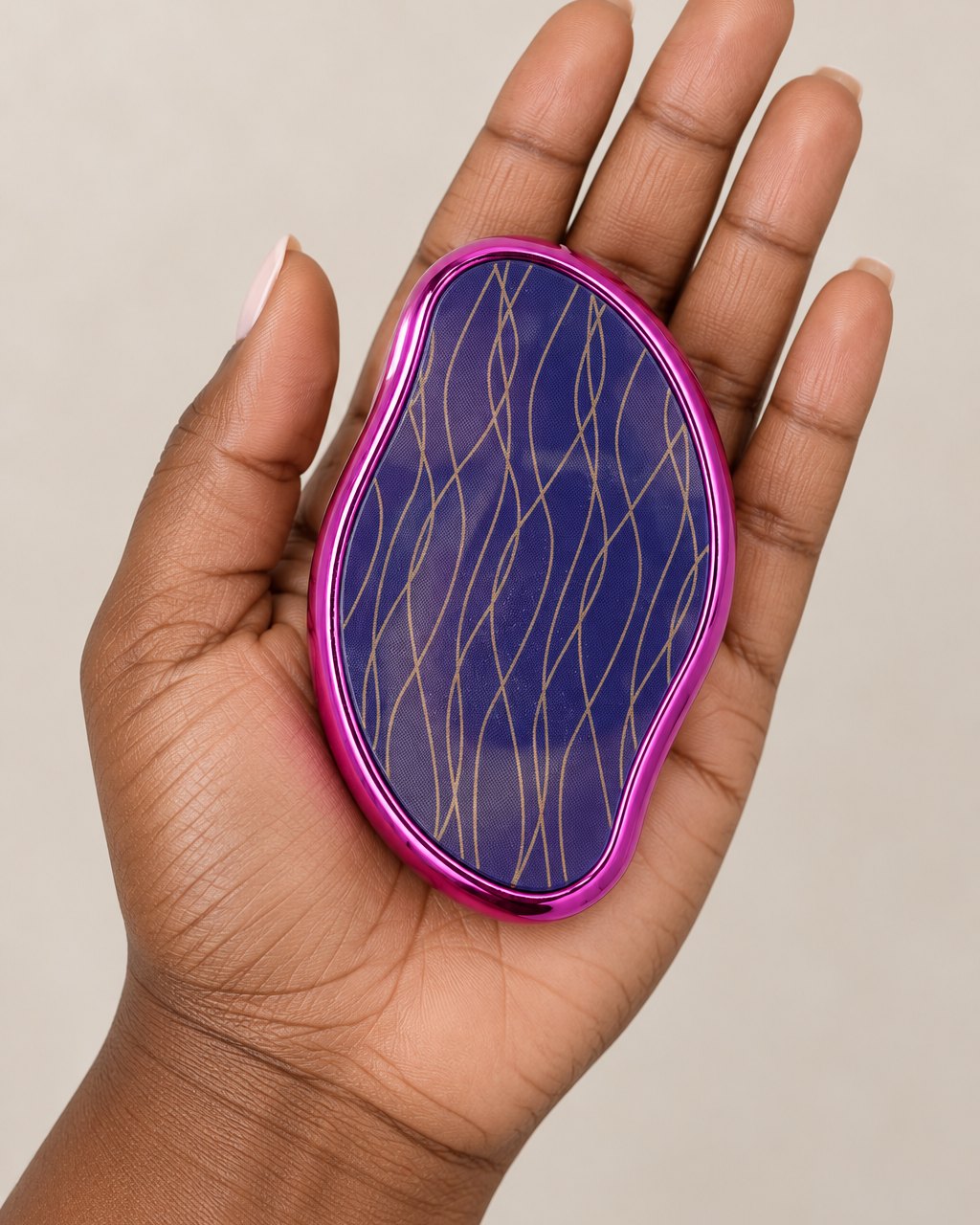Crystal hair eraser resting in an open palm, about the size of a bar of soap