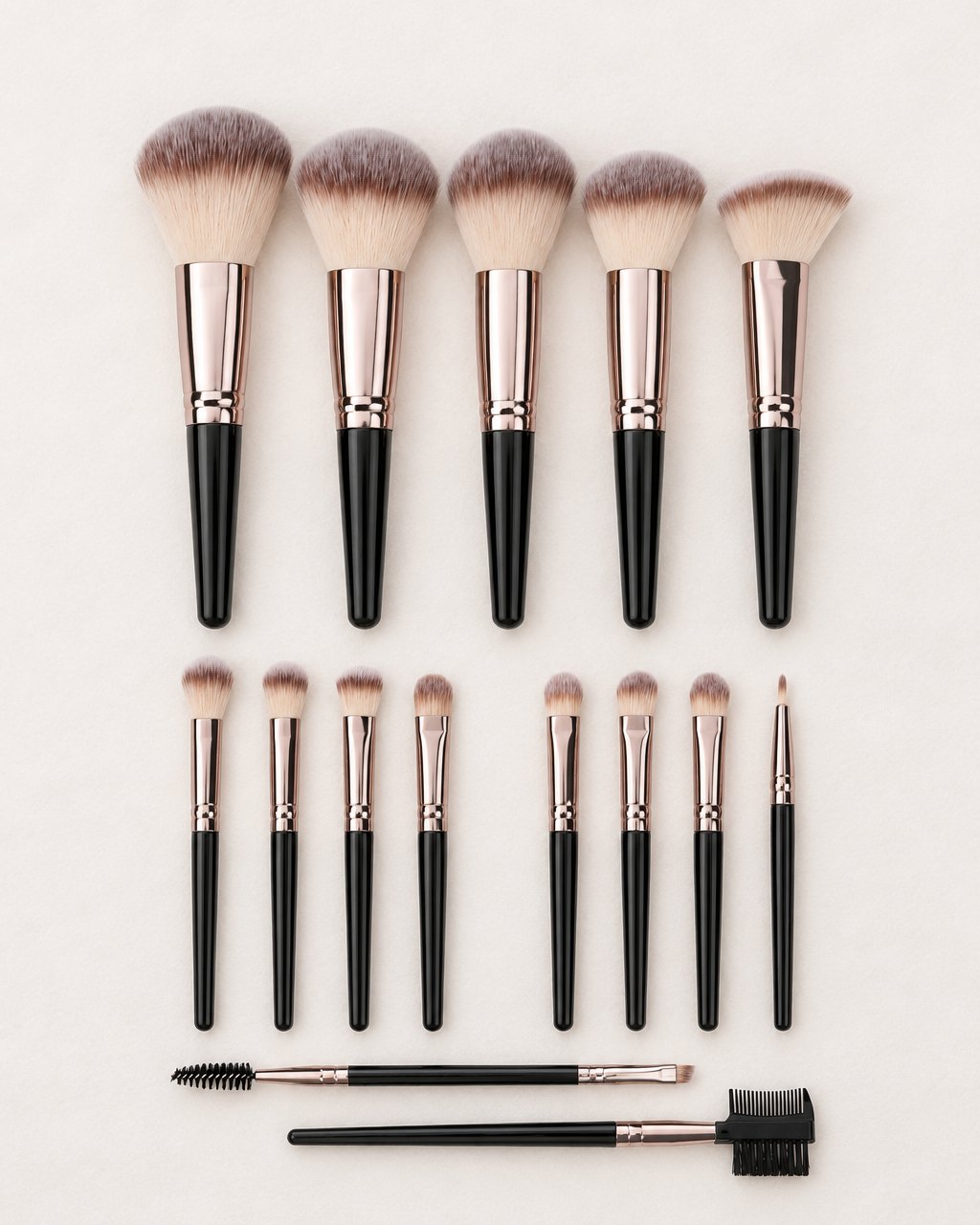 All 15 pieces laid out: five face brushes, eight eye brushes, a spoolie and a brow comb