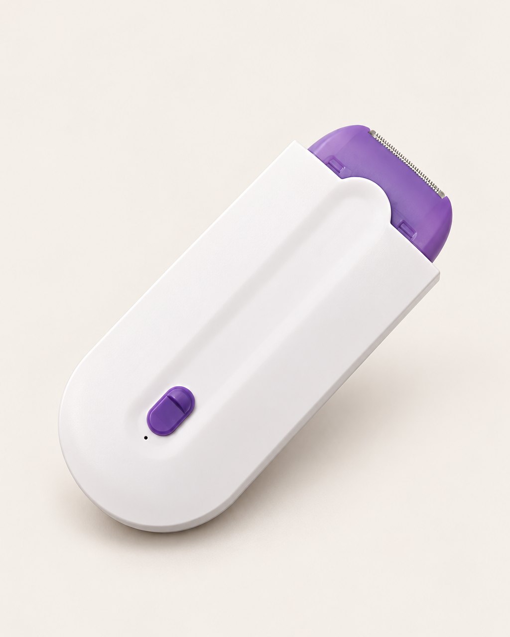 Palm-sized white hair remover with a purple head on a light background