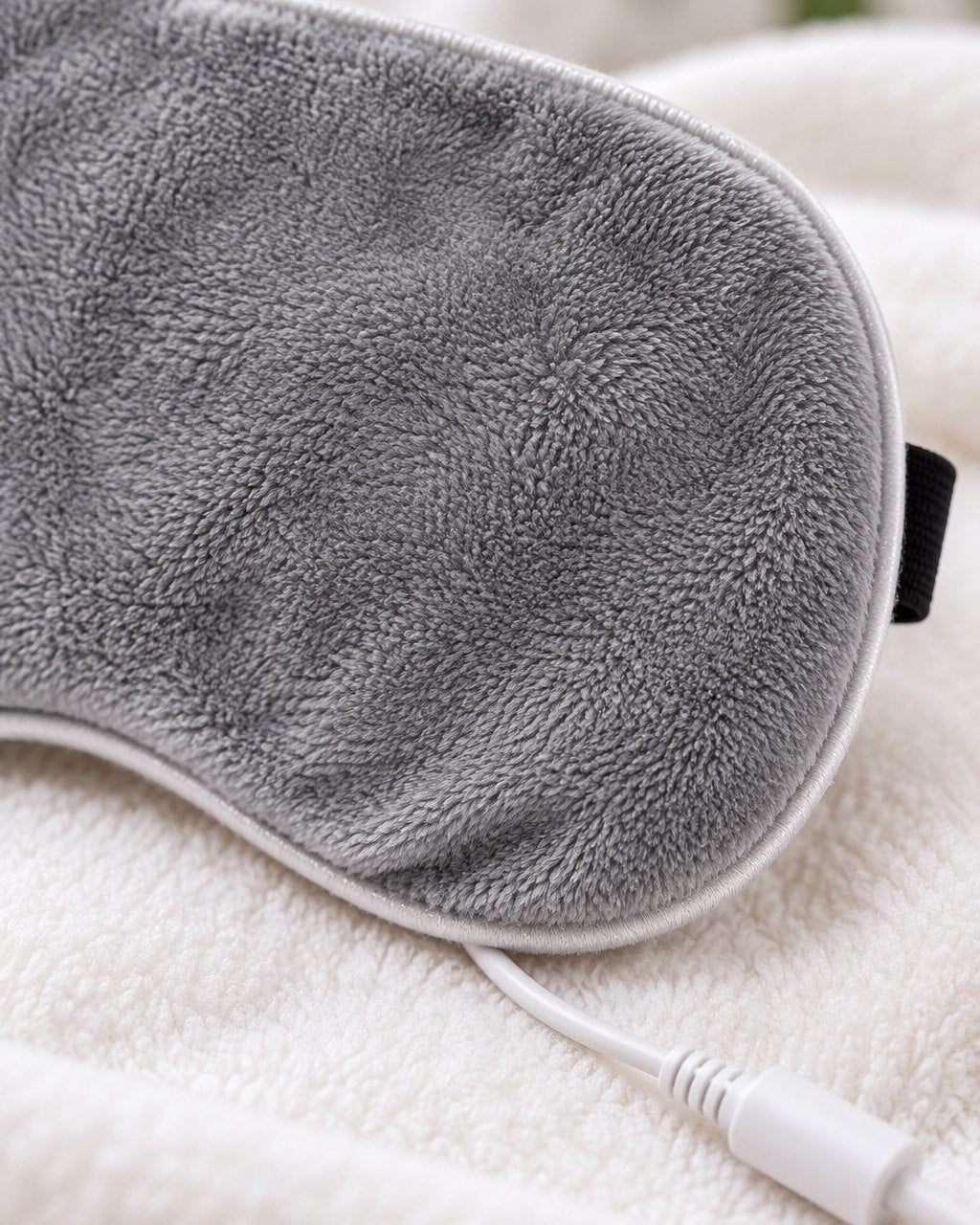 Close-up of the mask's plush flannel texture and the cable connector