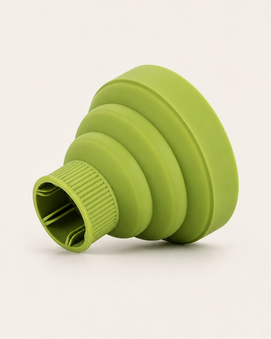 Green collapsible silicone hair diffuser, fully open, on a light background