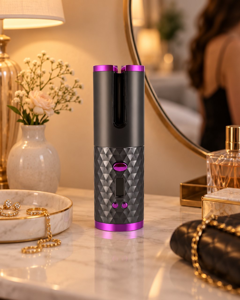 The curler standing on a dresser beside a jewellery dish and a round mirror