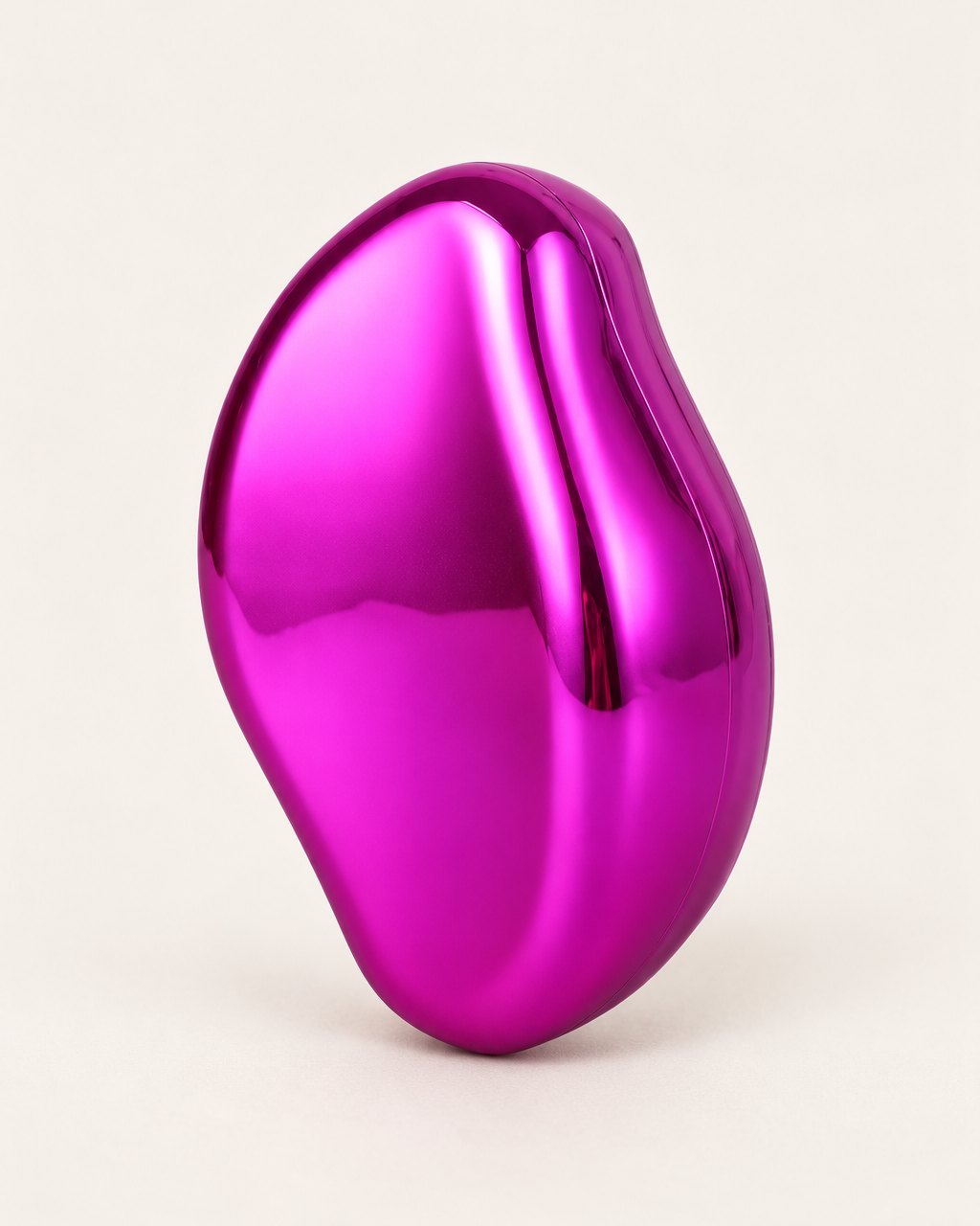 Rose crystal hair eraser showing its glossy, curved back, on a light background