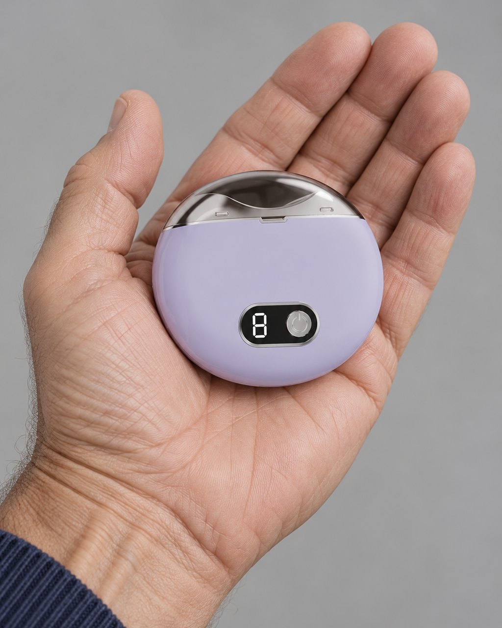 The palm-sized lilac nail clipper resting in one hand