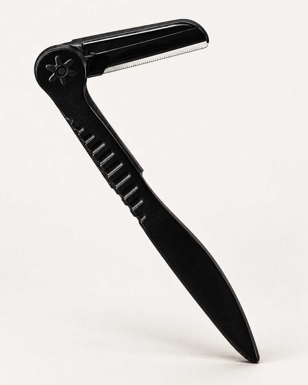 Black folding brow razor shown open on a light background