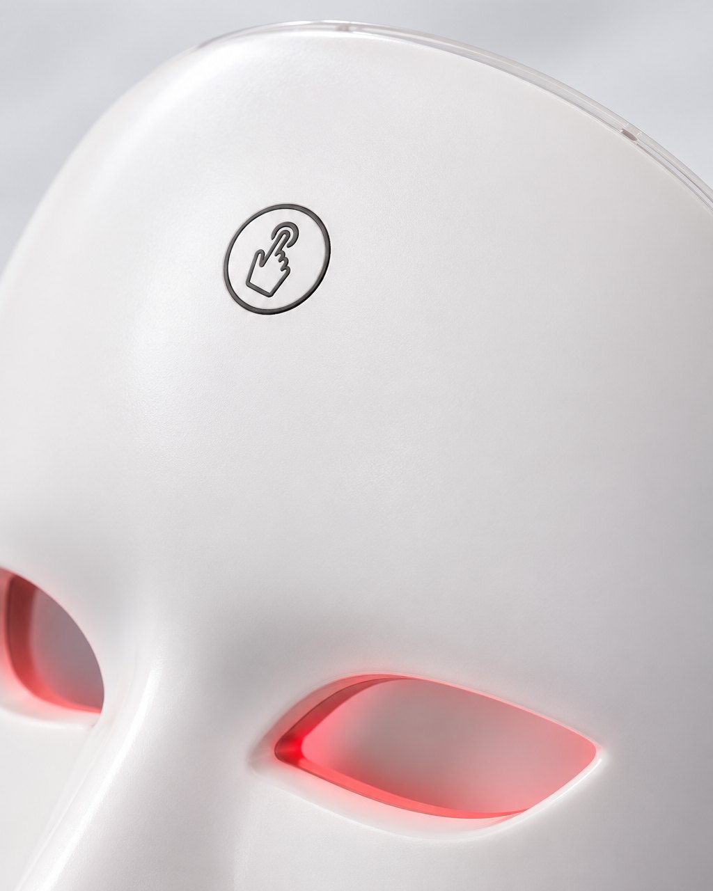 Close-up of the touch button on the forehead of the white LED face mask