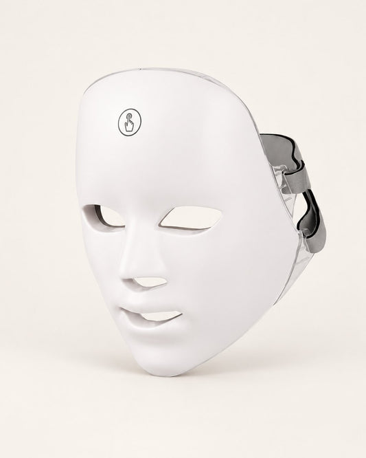 White LED face mask with a touch button on the forehead, on a light background