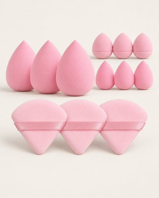 Pink set of twelve makeup sponges and triangle powder puffs laid out on a light background