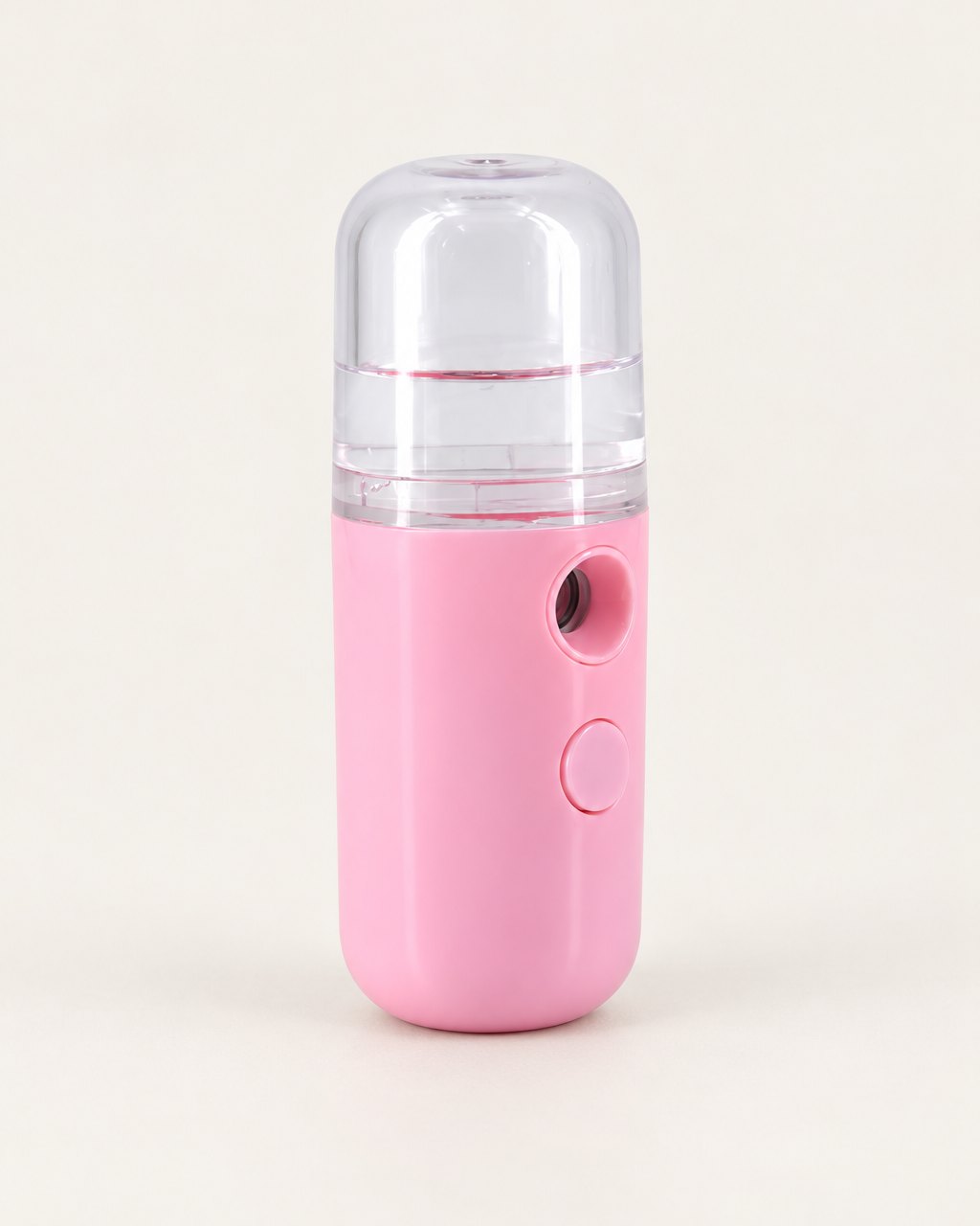 Pink pocket nano facial mister with a clear tank on a light background