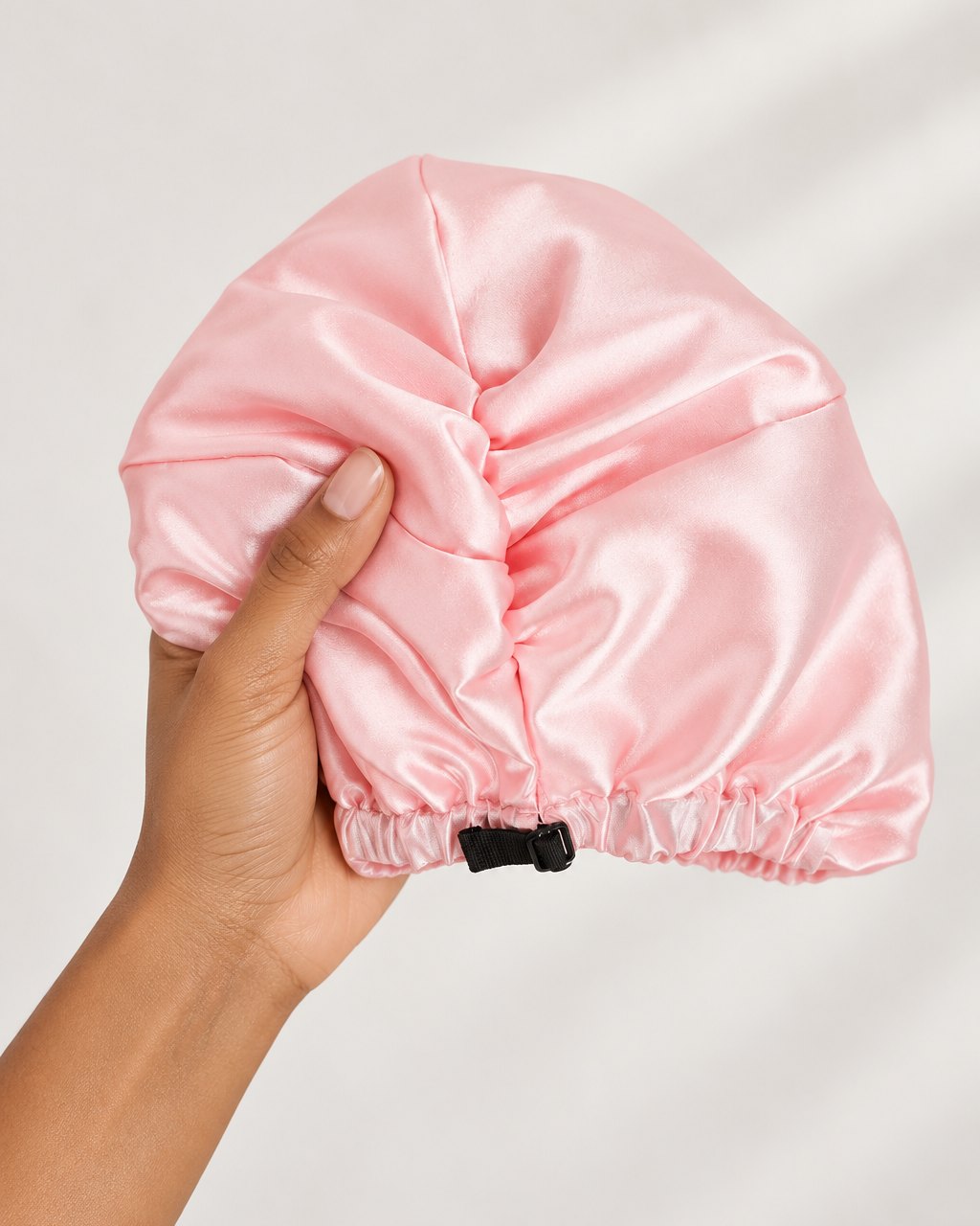 The turban folded small in one hand