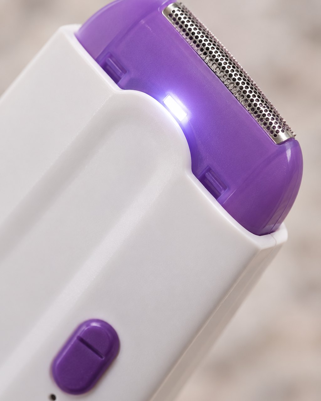Close-up of the purple cutting head and the small light at its edge