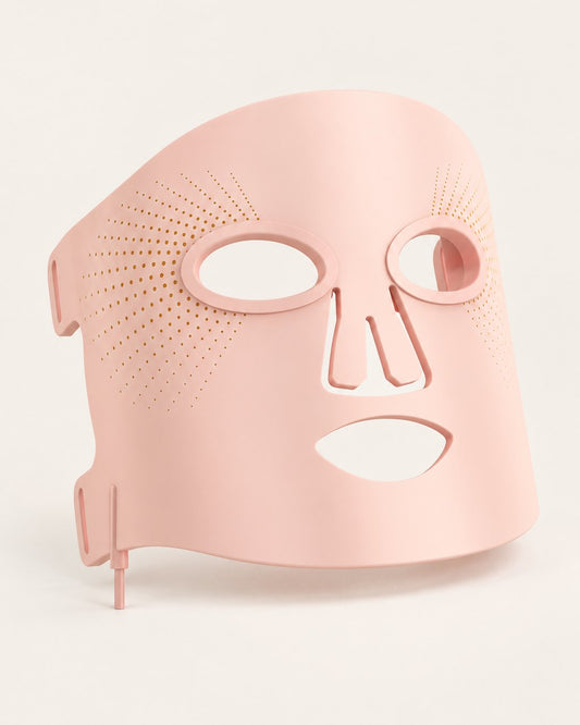 Pink flexible silicone LED face mask on a light background