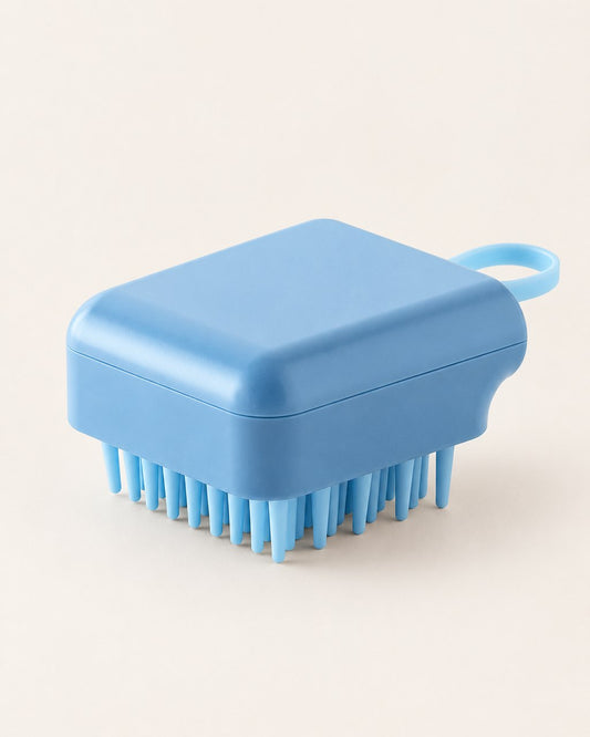 Blue palm-sized scalp shampoo brush with soft silicone bristles and a side loop