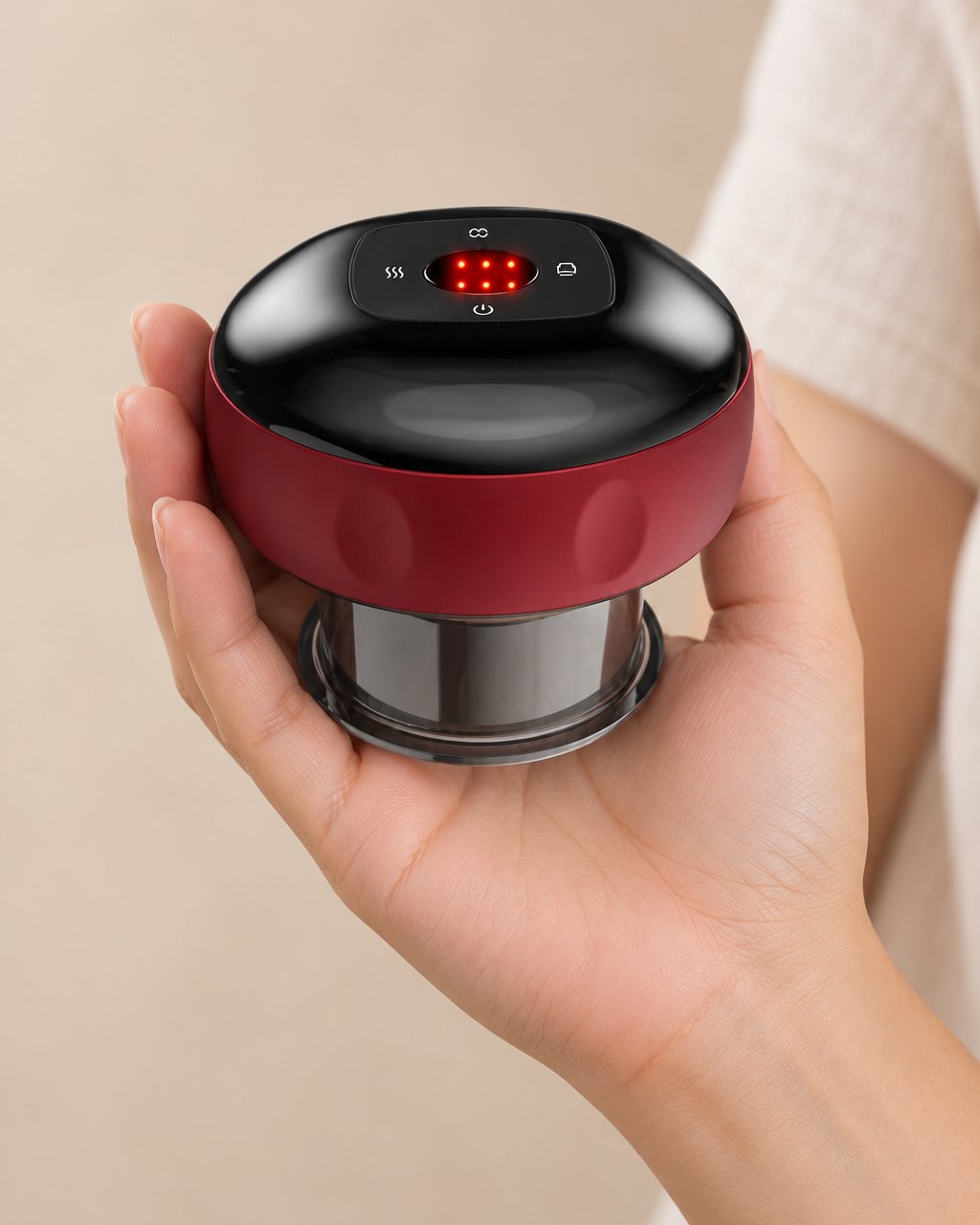 The cupping massager held in one hand, about the size of a palm