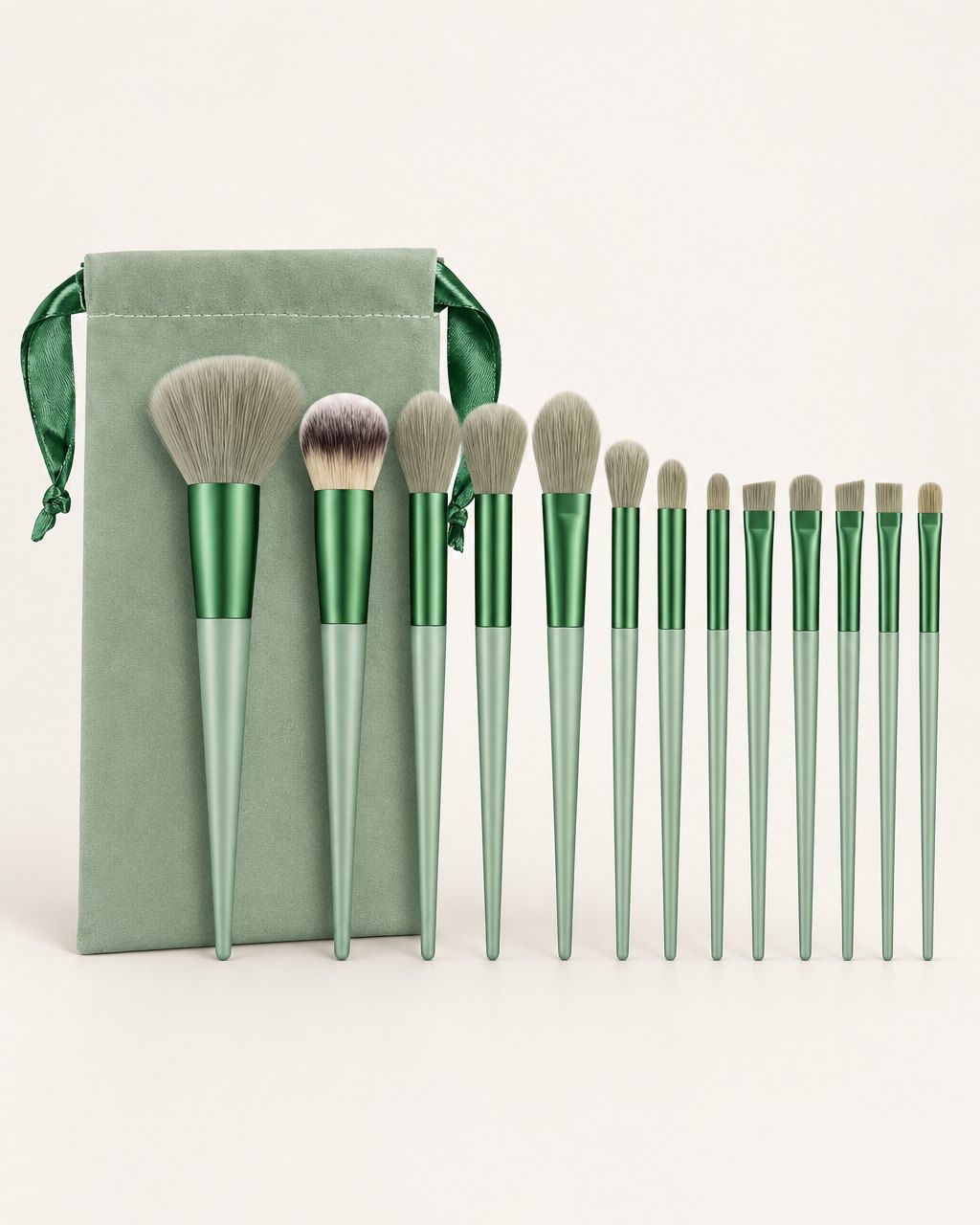 Sage green 13-piece brush set fanned out above its matching drawstring pouch