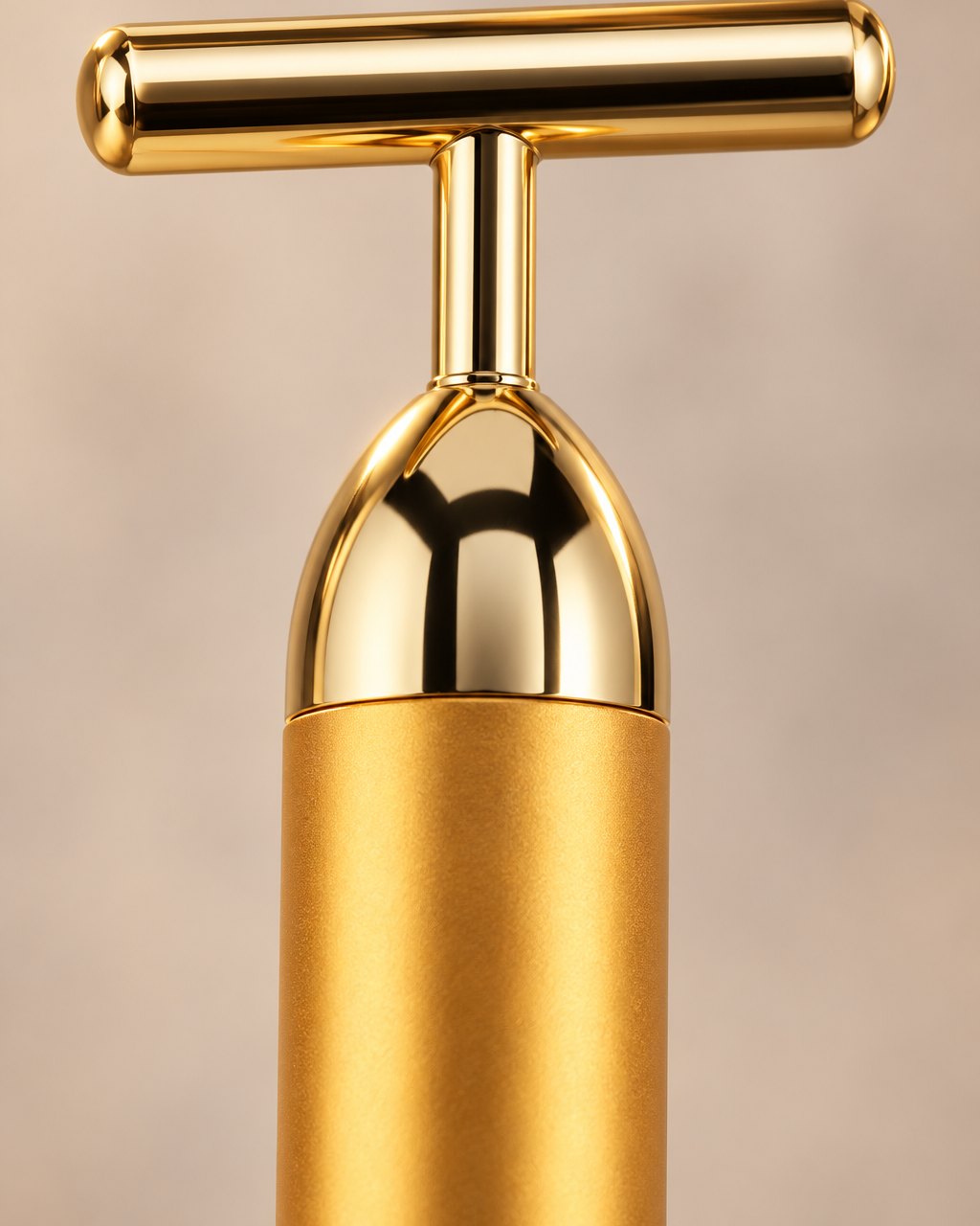 Close-up of the bar's polished gold T-head and domed top cap
